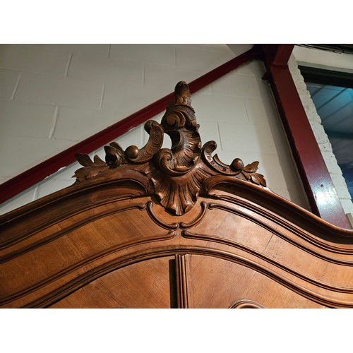 1005 - A late 19th Century French walnut armoire, carved acanthus leaf finial on carved fore legs, 244cm ta... 