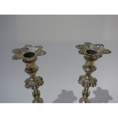 8002 - A pair of George III Ebeneezer Coker solid silver candlesticks with shell and rope detail, shaped ci... 