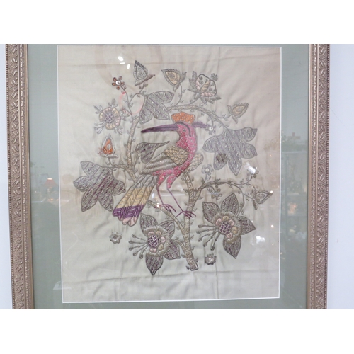 4015 - An embroidered panel depicting exotic bird on blossoming branch, framed and glazed, 38cm x 23cm imag... 