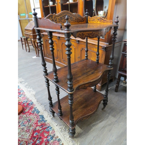 4069 - A rosewood three tier whatnot with turned spindle supports, three quarter inlaid gallery, 103cm tall... 