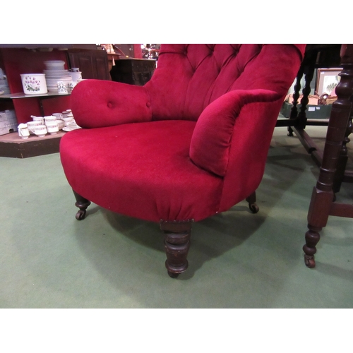 4147 - A Victorian button back armchair, red upholstery on turned fore legs to castors