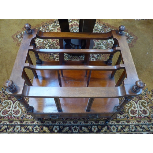 4231 - A circa 1880 walnut three division canterbury on finial turned supports and base drawer over black c... 