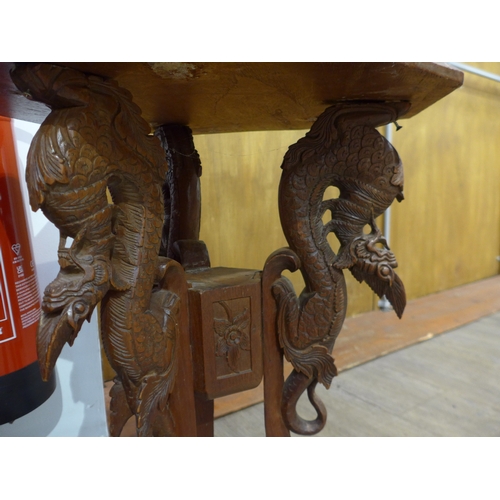 4257 - An Anglo-Indian carved occasional table with mythical creature base, 62cm tall