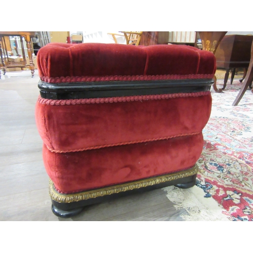 4146 - A Victorian upholstered and ebonised box seat ottoman, the hinged buttoned seat over bun feet and wh... 