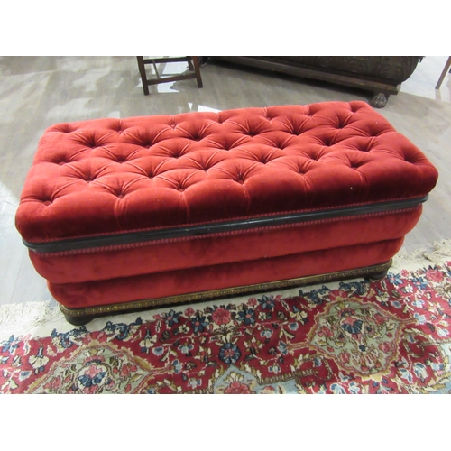 4146 - A Victorian upholstered and ebonised box seat ottoman, the hinged buttoned seat over bun feet and wh... 