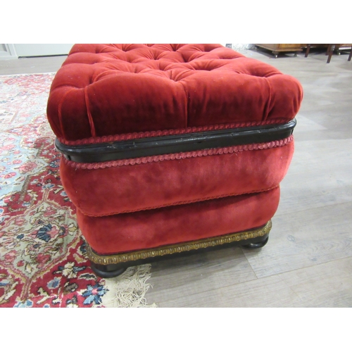 4146 - A Victorian upholstered and ebonised box seat ottoman, the hinged buttoned seat over bun feet and wh... 