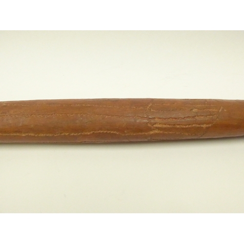 4167 - An Australian carved nalla throwing stick, 59cm long