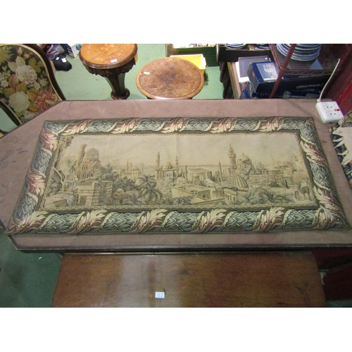 4010 - A tapestry wall hanging of a Middle Eastern town with floral border, 69cm x 160cm