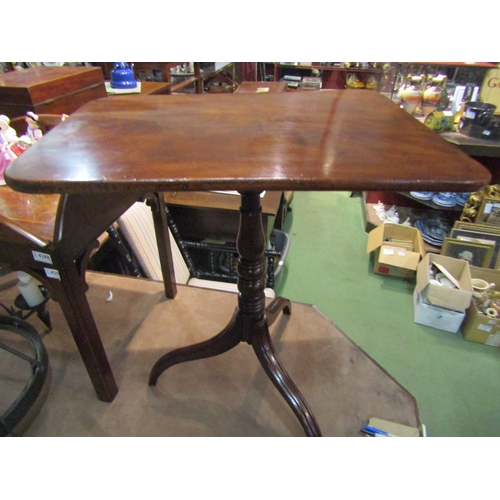 4286 - A George III flame mahogany round cornered tilt-top wine table over a baluster and ring-turned colum... 