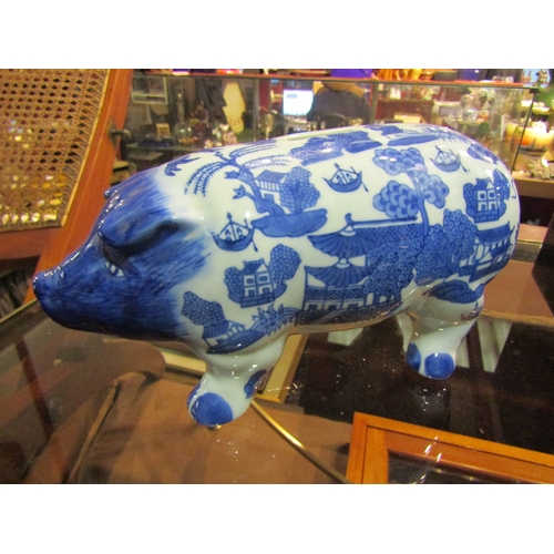 An Oriental design blue and white ceramic piggy bank money box, 25cm long