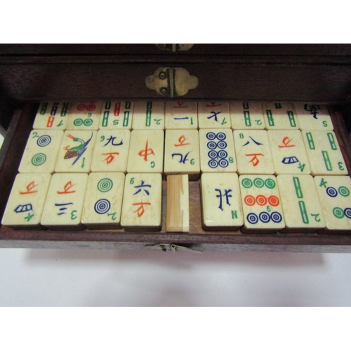 1011 - An early 20th Century bone and bamboo Mahjong set, housed within a fitted case with drawers