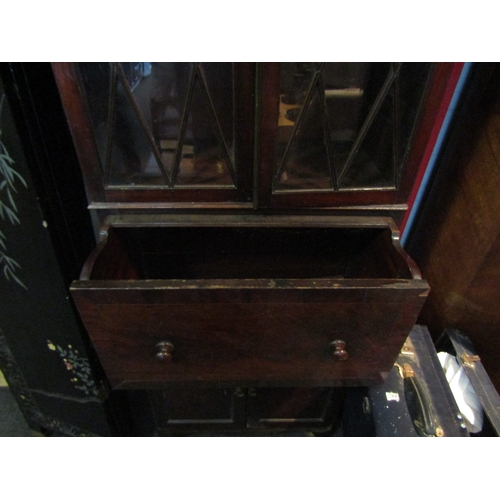 1073 - A 19th Century mahogany full height cabinet of slim proportions, the astragal glazed two door top ov... 