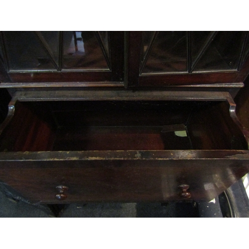 1073 - A 19th Century mahogany full height cabinet of slim proportions, the astragal glazed two door top ov... 