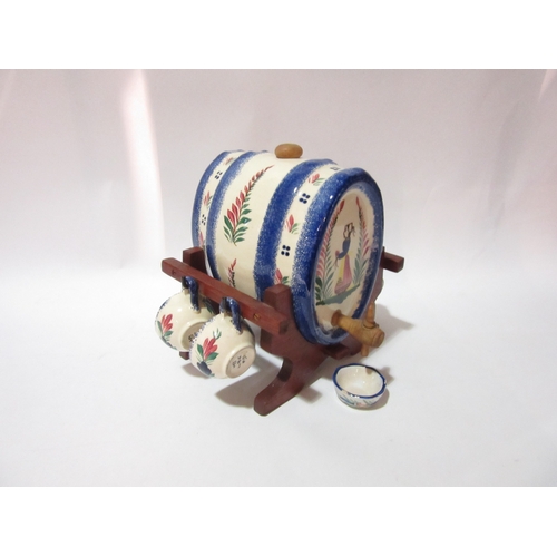 4354 - A Quimper pottery spirit barrel on wooden stand, flower sprigs and female design with four matching ... 