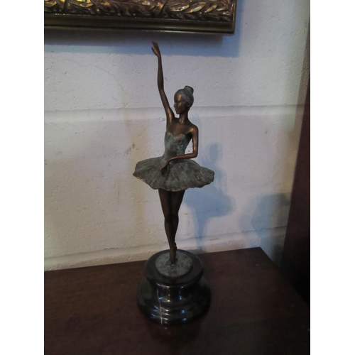 1007 - A verdigris bronze ballerina on point, 31cm tall, mounted on a marble plinth