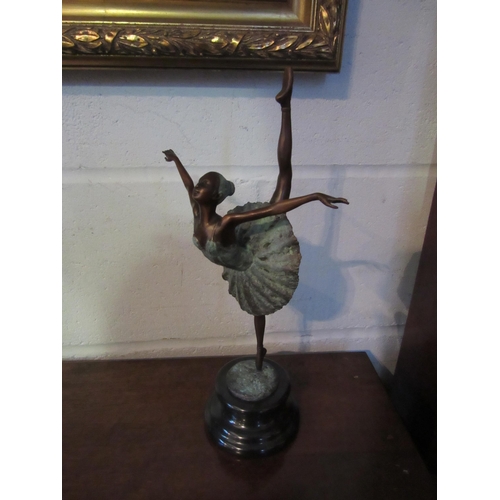 1010 - A verdigris bronze ballerina on point, 33cm tall, mounted on a marble plinth