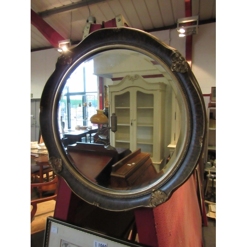 1059 - A gilt framed bevel edged circular wall mirror.  Mirror plate 34cm diameter