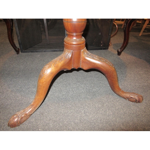 1111 - A Georgian mahogany tripod table with birdcage mechanism, carved legs to claw and ball feet, 70cm ta... 