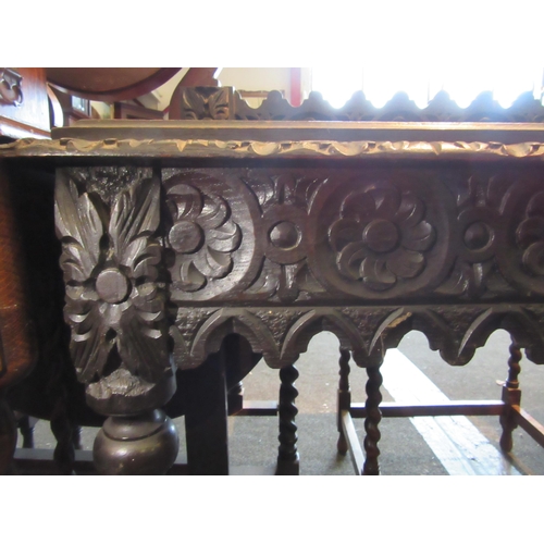 1127 - A Gothic style oak hall table with carved decoration, shaped frieze and turned legs, 88cm tall x 105... 