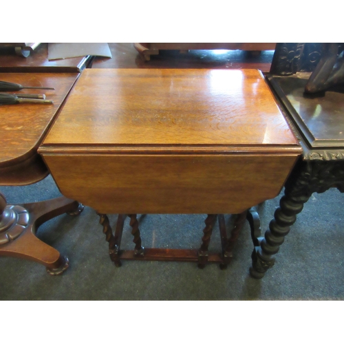 1129 - A 1940's oak full flap table raised on barley-twist supports