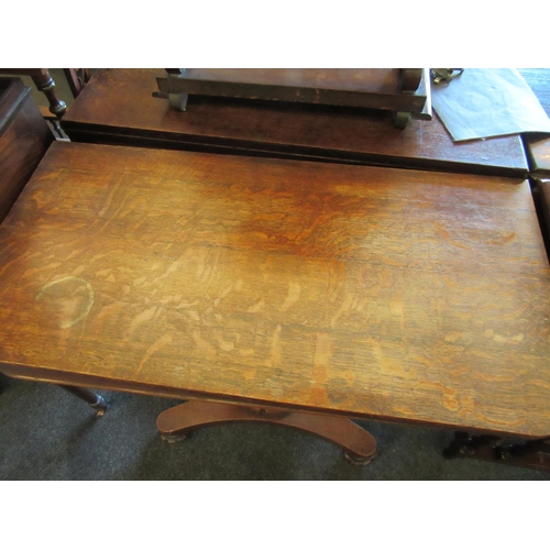 1131 - An oak card table raised on turned column and plateau base