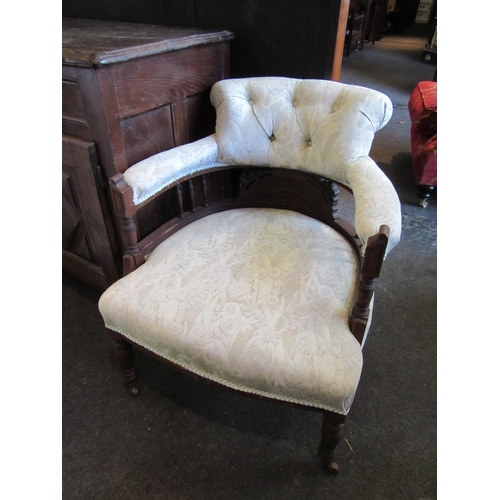 1165 - A pair of early 20th Century tub chairs, spindle rail, button beige upholstery turned supports on po... 