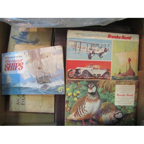 1191 - A box of assorted tea cards, cigarette cards, photographs album, etc.