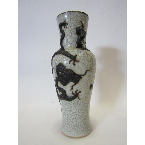 1374 - A Japanese crackle ware vase with black relief of dragon, character marks to base, 25cm tall