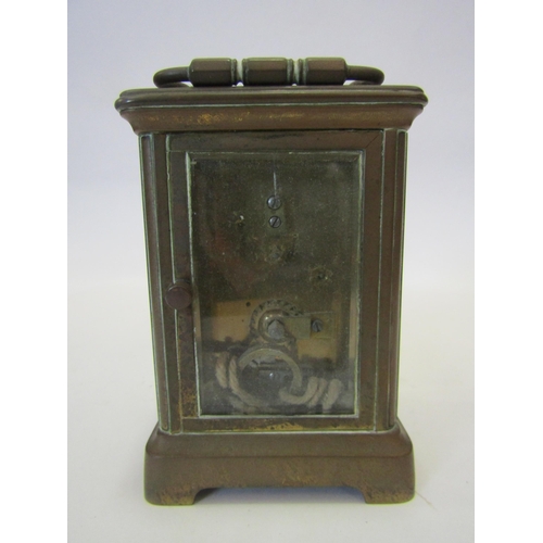 1378 - A brass cased carriage clock, bevelled glass panels. With key