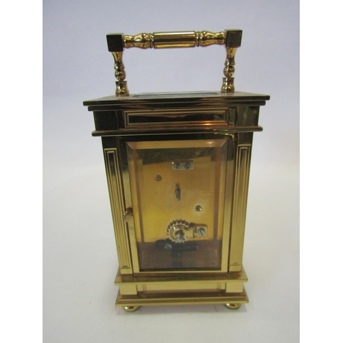 1379 - A brass four panel carriage clock, Roman numerated chapter ring, visible escapement, retailed by WM.... 