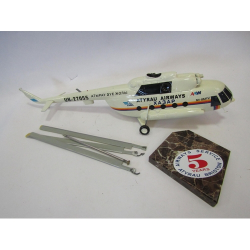 1383 - An Atyrau Airways XA3AP helicopter with marble stand commemorating 