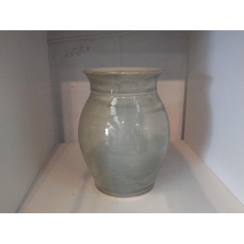 1416 - A studio ceramic celadon vase, folded rim, of baluster form 20cm tall