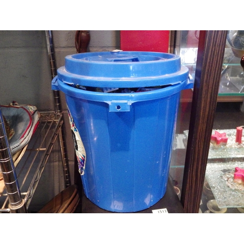 1511 - A blue plastic lidded dustbin containing a quantity of 