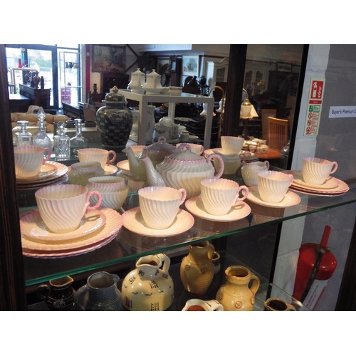 1516 - A Belleek part tea set, wrythen form pink blush rope twist handle including teapot, six tea plates, ... 