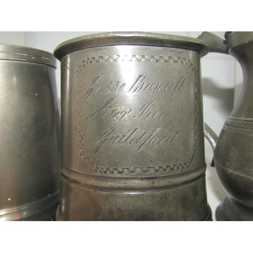 1451 - Three pewter tankards, various designs.