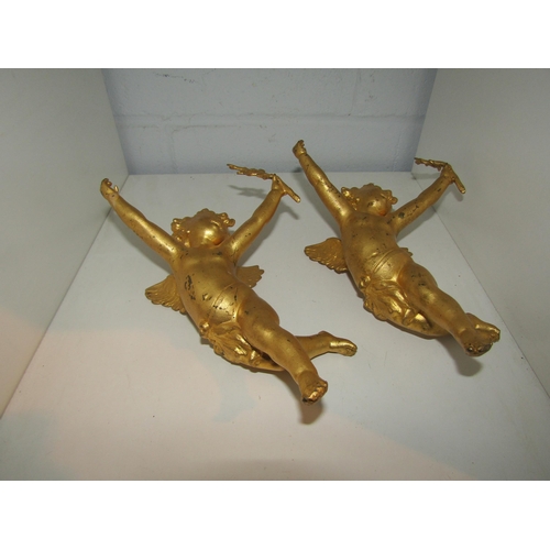 1459 - Two gilt metal winged putti holding branches.  Approximately 21cm overall height.  Loop fixing to ba... 