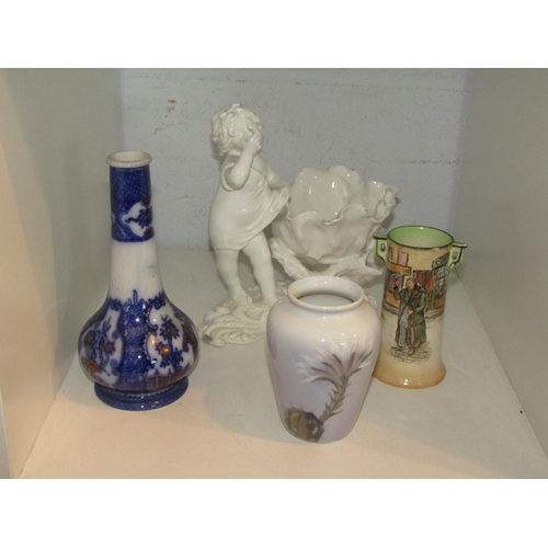 1461 - A blanc-de-chine centrepiece, cherub side shell supported by coral A/F, a Royal Doulton 