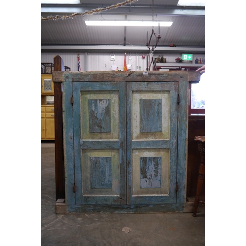 2005 - An 18th Century Sri Lankan, painted hardwood window frame, with two doors, opening to reveal iron ba... 