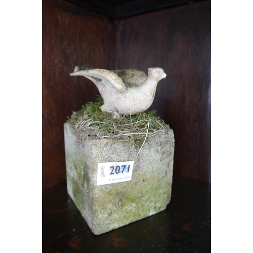 2071 - A carved bird figure mounted on stone