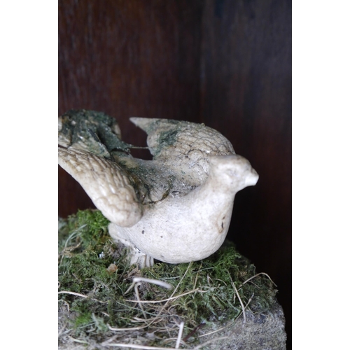 2071 - A carved bird figure mounted on stone