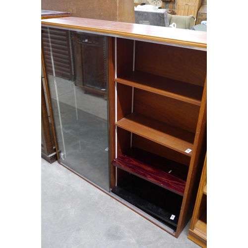 2395 - A mid century glazed bookcase with sliding doors