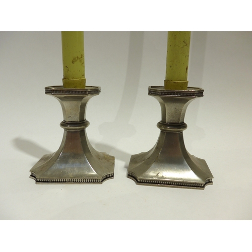 4057 - A pair of V & A Royal Selangor pewter candlesticks with paraffin wicked candles, 38cm tall