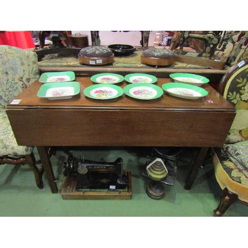 4071 - A Georgian mahogany drop-leaf dining table on castors