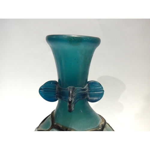 4075 - A Continental Art glass vase in turquoise with overall web casing, 28cm tall