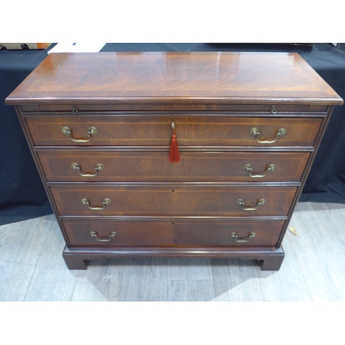 4111 - A George III revival crossbanded mahogany bachelor's chest, the brushing slide over four drawers on ... 