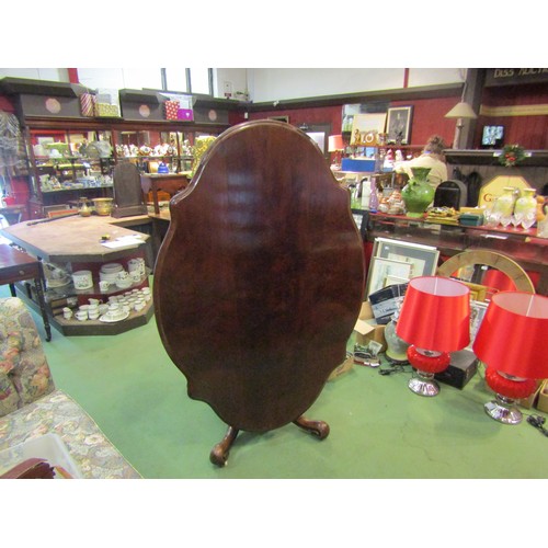 4196 - Circa 1850 a walnut tilt-top table, the serpentine sided top over a melon fluted and turned column o... 