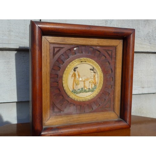 4328 - An early 19th Century Prattware plaque moulded in relief depicting a seated and standing gentleman a... 