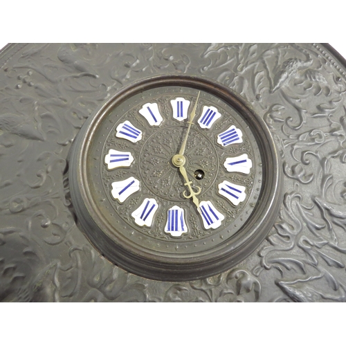 8028 - A cast metal wall hanging clock with ornate dial having enamel Roman numeral cartouches on an ornate... 