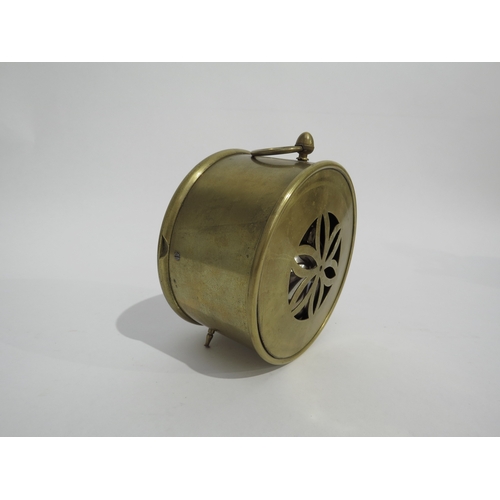 8073 - A brass drum form desk clock, white enamel Roman numeral dial with twin barrel movement striking a b... 