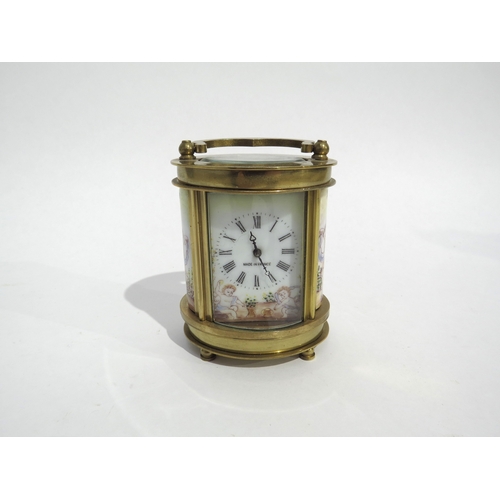 8109 - A miniature French oval brass cased carriage timepiece, coloured enamel panels to sides depicting Ch... 